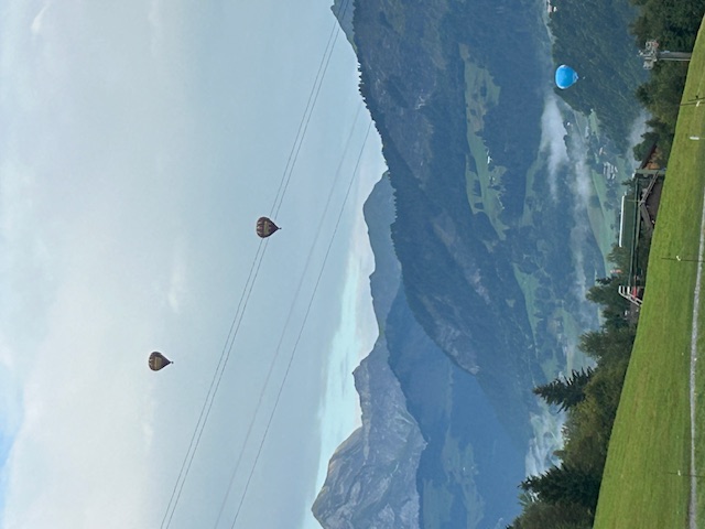 View of hot air balloons over the Alps